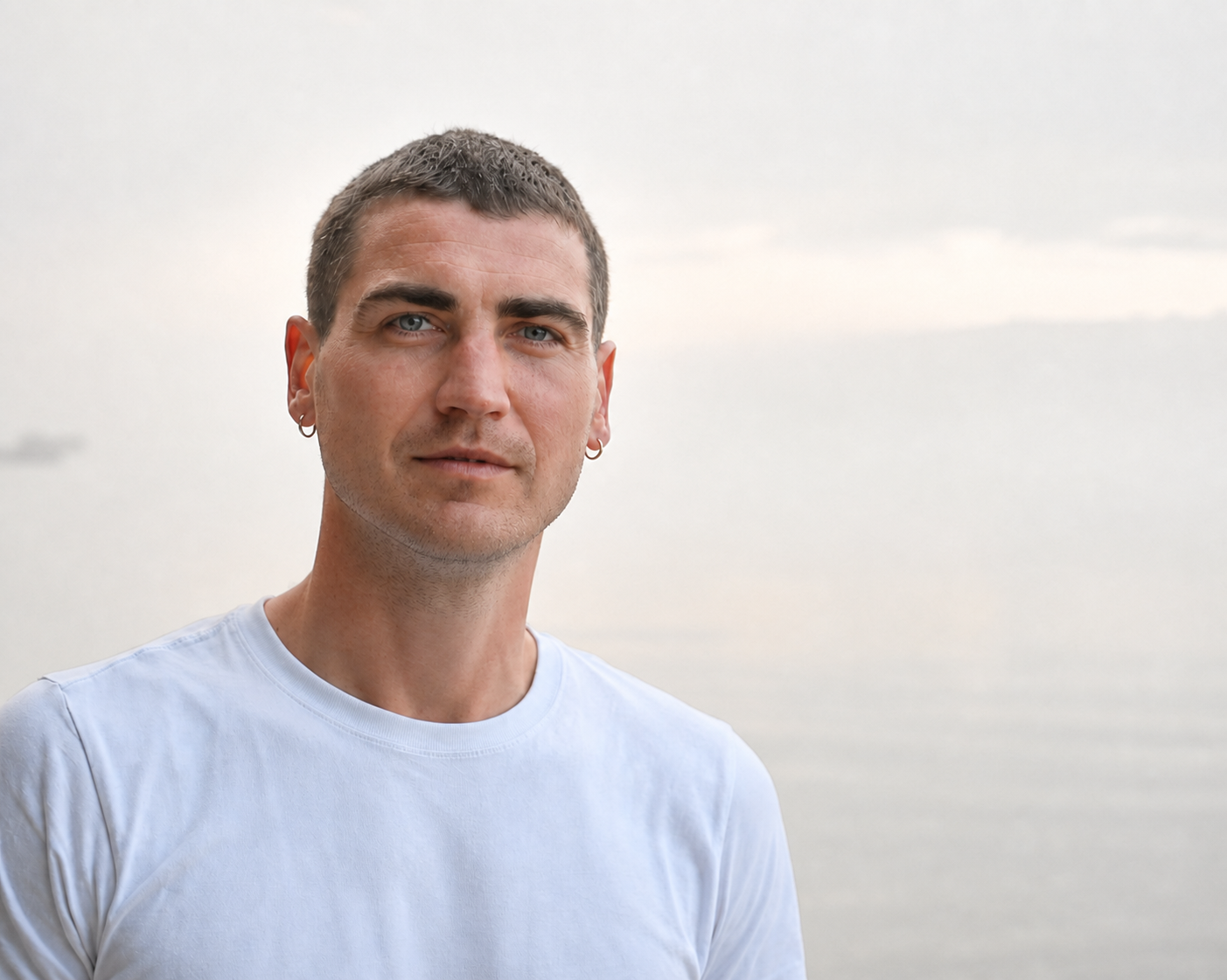 Portrait of Cezary Baraniecki against a quiet, misty outdoor background.